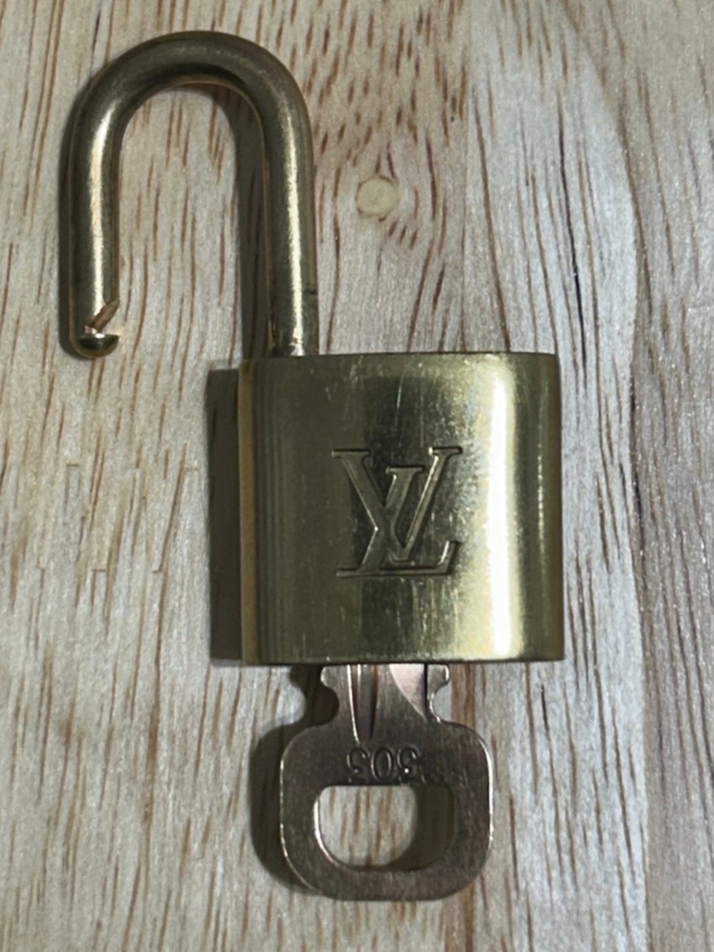Gold Louis Vuitton lock w/ key, #303